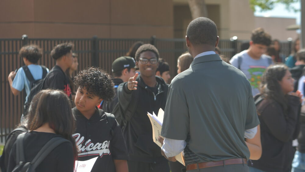 A group of students and community members speaking with a facilitator during a Power of Water Foundation wellness workshop, focused on mental, emotional, and physical health education.