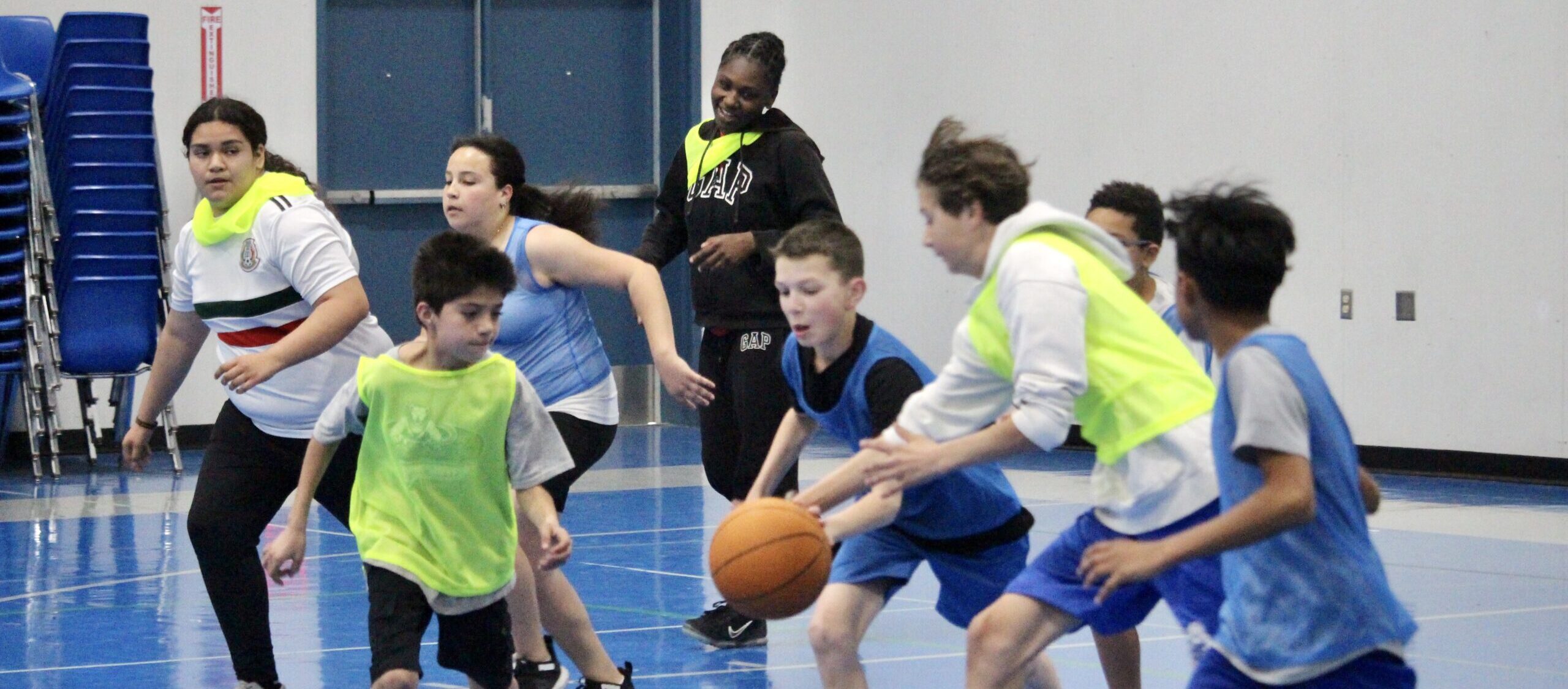 Children participating in an indoor basketball session organized by the Power of Water Foundation, combining physical activity with cognitive and emotional support.